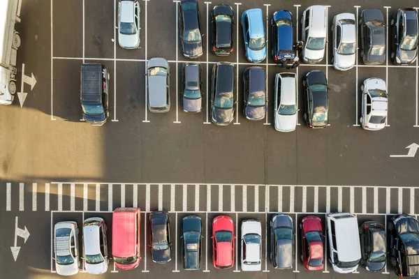 Top view of many cars parked on a parking lot.