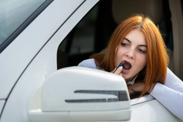 Closeup Young Redhead Woman Driver Correcting Her Makeup Dark Red — 스톡 사진