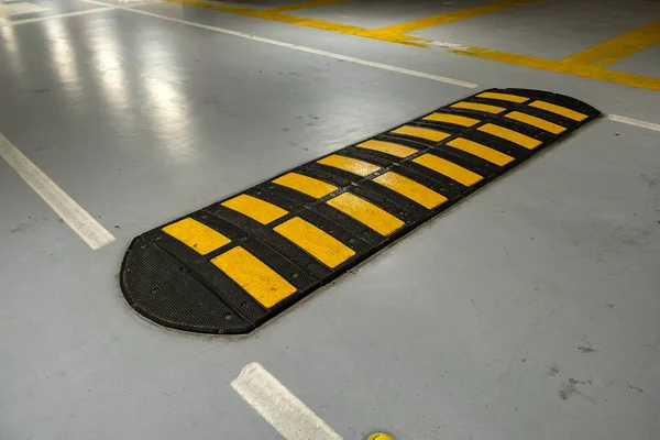 depositphotos_348055510-stock-photo-striped-black-yellow-speed-bump.jpg