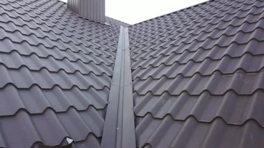 İnşaat halindeki metal kiremitlerle kaplı ahşap çatı yapısı olan bitmemiş evin havadan görüntüsü..