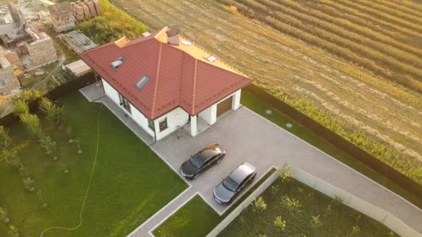 Top down aerial view of a private house with red tiled roof and spacious yard with parked two new cars. — Stock Footage Top Aerial View Private House Red Tiled Roof Spacious Yard Royalty Free Stock Video