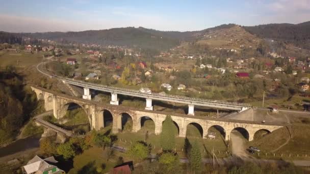 カルパチア山脈 ウクライナのヴォロフタの町で古い荒廃した列車の橋の空中ビュー — ストック動画