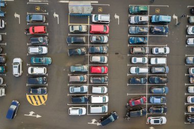 Top view of many cars parked on a parking lot.