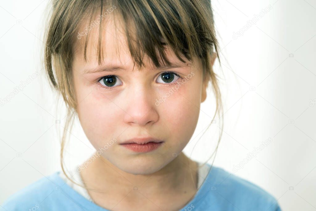 Closeup portrait of sad crying child girl.