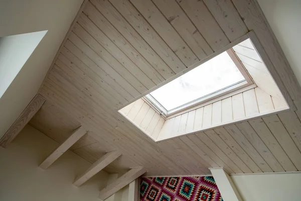 Wooden ceiling in a contemporary mansard room with attic window ob decorative planks surface. — Stock Image Wooden Ceiling Contemporary Mansard Room Attic Window Decorative Planks Surface Royalty Free Stock Images
