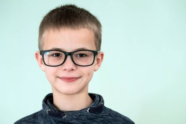 Gözlük takan bir çocuğun yakın portresi..