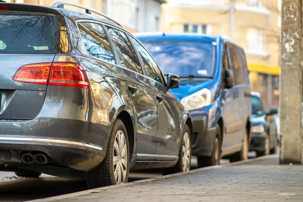 Kyiv, Ukraine - February 16, 2020: Modern cars parked on city street side in residential discrict. Shiny vehicles parked by the curb. Urban transportation infrastructure concept.