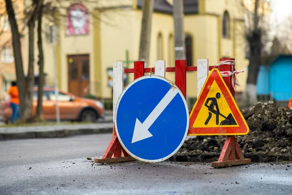 Warning street sign on road work site.