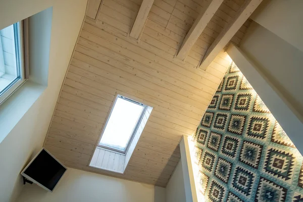 Wooden ceiling in a contemporary mansard room with attic window ob decorative planks surface. — Stock Image Wooden Ceiling Contemporary Mansard Room Attic Window Decorative Planks Surface Royalty Free Stock Images