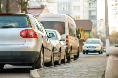 Kyiv, Ukraine - February 16, 2020: Modern cars parked on city street side in residential discrict. Shiny vehicles parked by the curb. Urban transportation infrastructure concept.