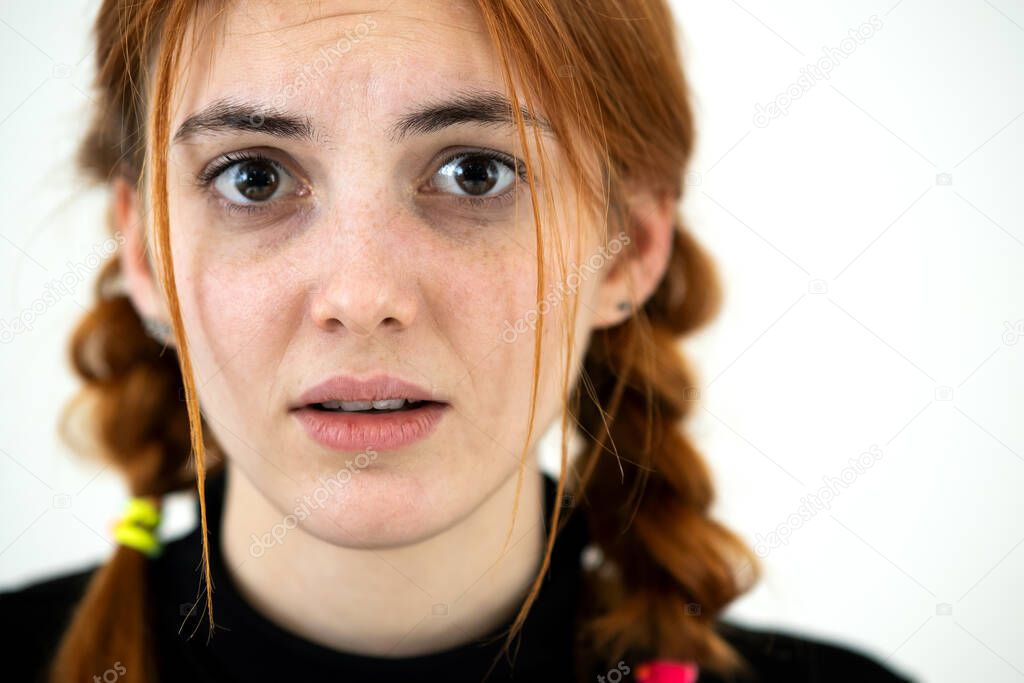 Close up portrait of innocent looking redhead pretty teenage girl.