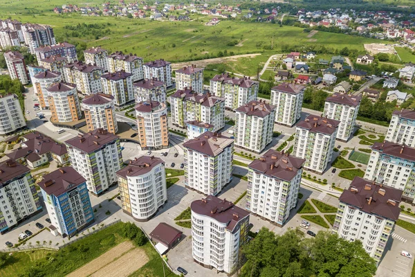 Top view of apartment or office tall buildings, parked cars, urban city landscape. Drone aerial photography.