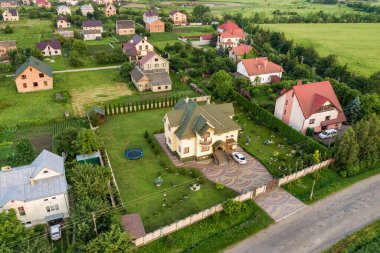 Konut evleri ve yeşil ağaçlarla dolu küçük bir kasaba ya da köyün havadan manzarası.