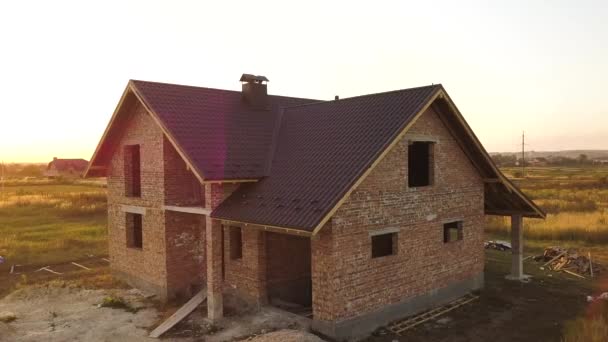 Aerial view of unfinished house with wooden roof structure covered with metal tile sheets under construction. — Stock Footage Aerial View Unfinished House Wooden Roof Structure Covered Metal Tile Royalty Free Stock Footage