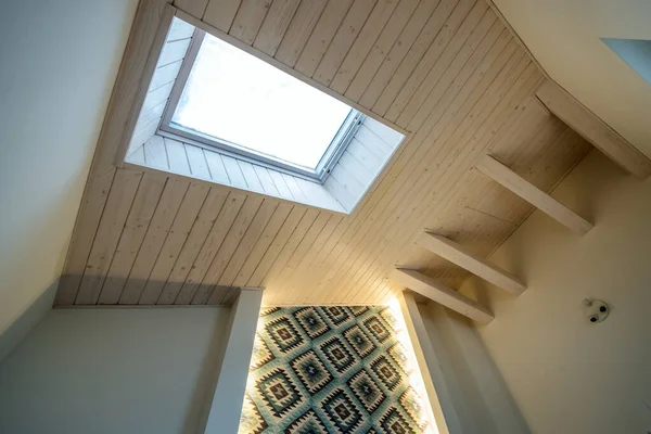 Wooden ceiling in a contemporary mansard room with attic window of decorative planks surface. — Stock Image Wooden Ceiling Contemporary Mansard Room Attic Window Decorative Planks Surface Stock Image