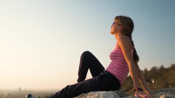 Young Relaxed Woman Sitting Outdoors Big Stone Enjoying Warm Summer — Stock Video