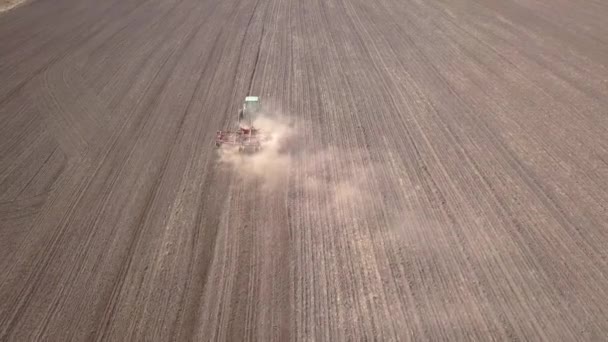 Top Aerial View Green Tractor Cultivating Ground Seeding Dry Field — Stock Video