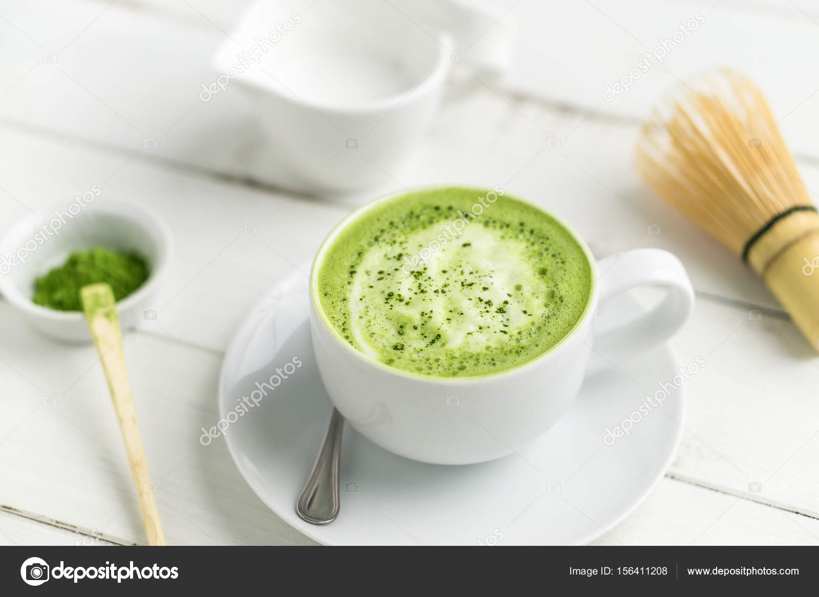 Cup of matcha green tea latte with accessories in background. Stock Photo  by ©Louno 156411208