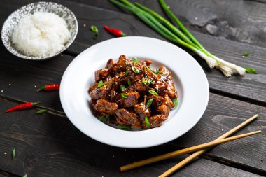 General Tso Chicken plate on dark background.