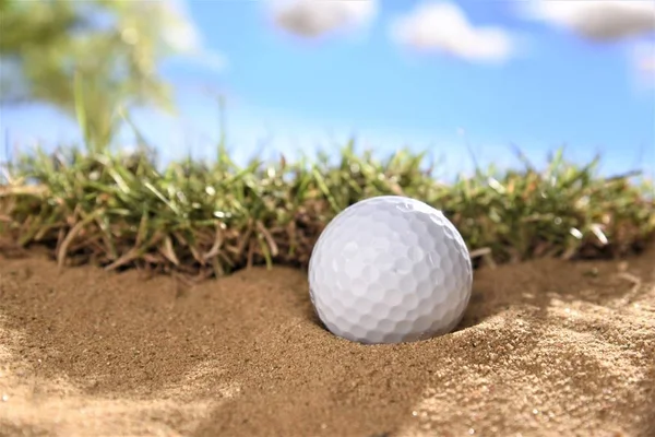 Golfbal in zand bunger — Stockfoto