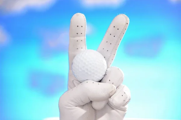 hand in glove holding golf ball make v sign