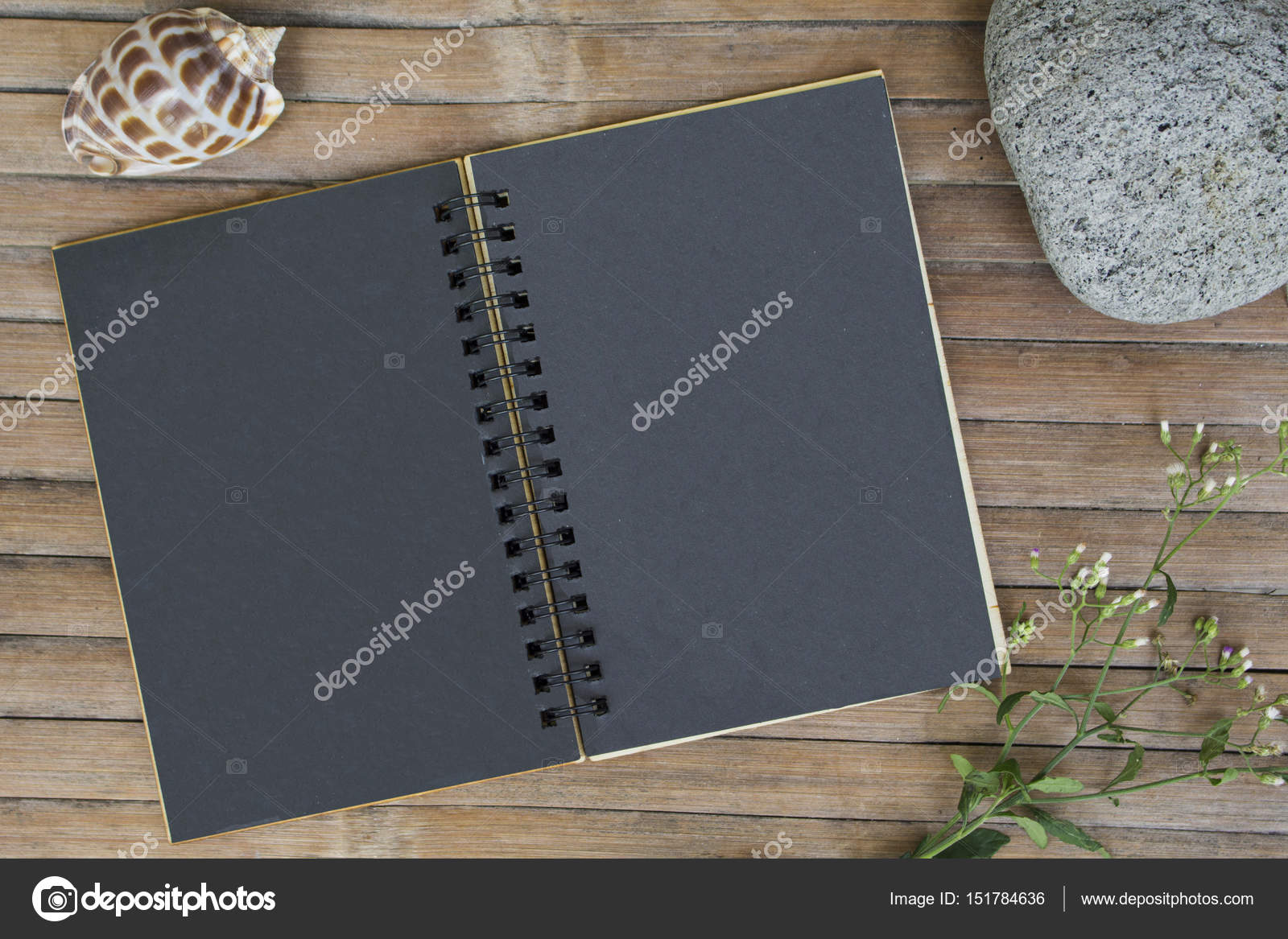 Black Paper Notebook On Rustic Wooden Background With Natural