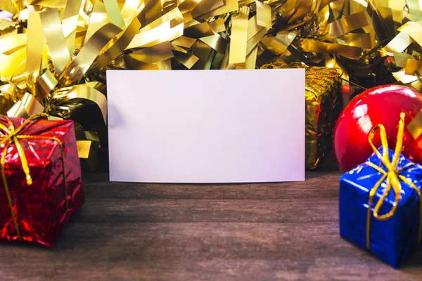 Empty business card in Christmas decor on wooden background.