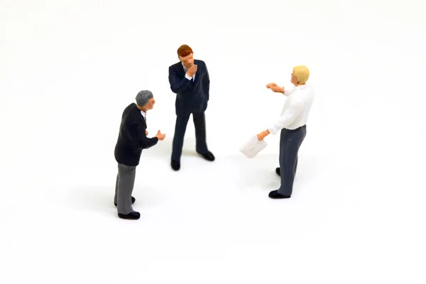 Miniature businessman on white background. Business men figurines macro photo