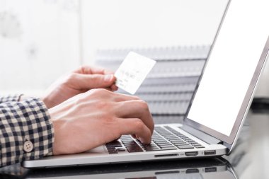 Plastik kart ve bir dizüstü bilgisayar ile el