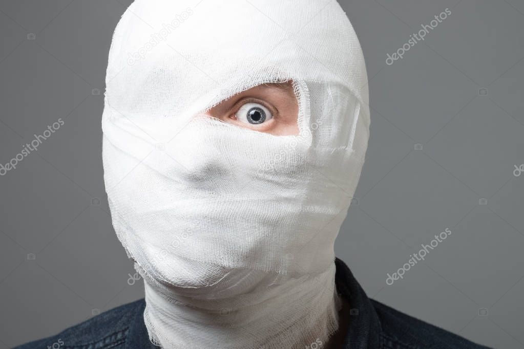 Man with bandage on his head