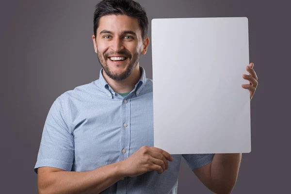 Youn man holds board — Stock Photo, Image