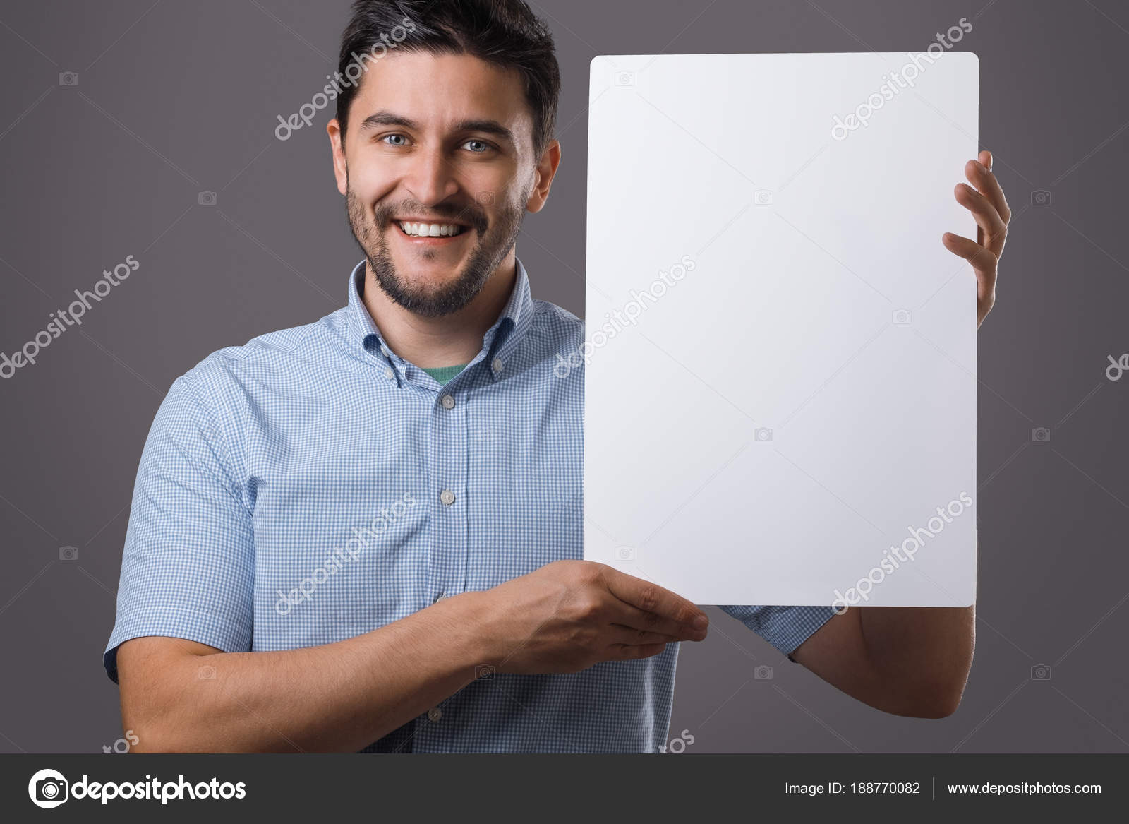 Youn man holds board — Stock Photo © 188770082