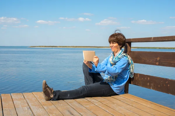 Joyful woman doing selfie using tablet