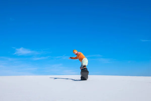 Sand boarder make a trick on the slope