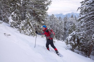 Yokuş yukarı snowshoeing için Gezgin adam gider 