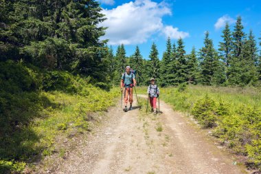 Baba ve oğul sırt çantaları ile yolda yürümek 
