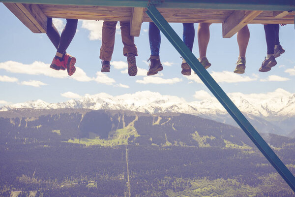 Legs of funny travelers over the mountain gorge