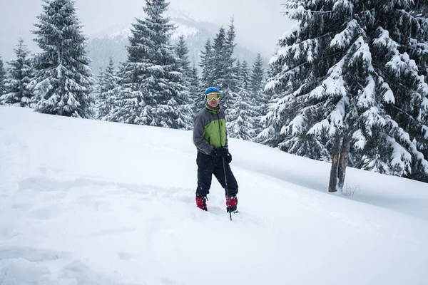 Авантюрист, в окулярах, стоїть у глибокому снігу — стокове фото