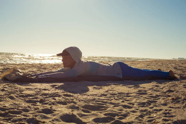 Woman traveler lays on the beach
