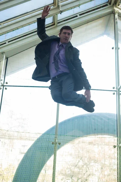 Confused businessman jumps