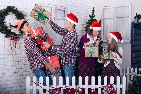 Cheerful family with a bunch of gifts in their hands