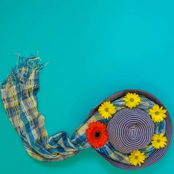 Sun blue hat decorated with red, yellow flowers and colorful sca — Stock Photo, Image