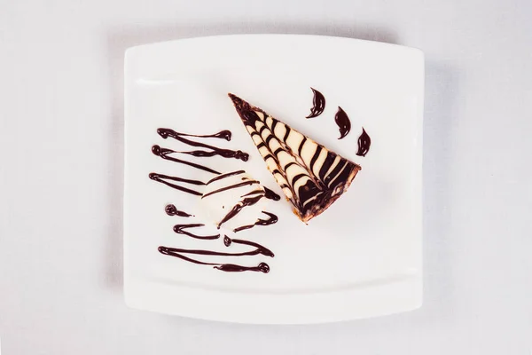 Dessert ice cream chocolate cake on white plate on a light backg — Stock Photo, Image