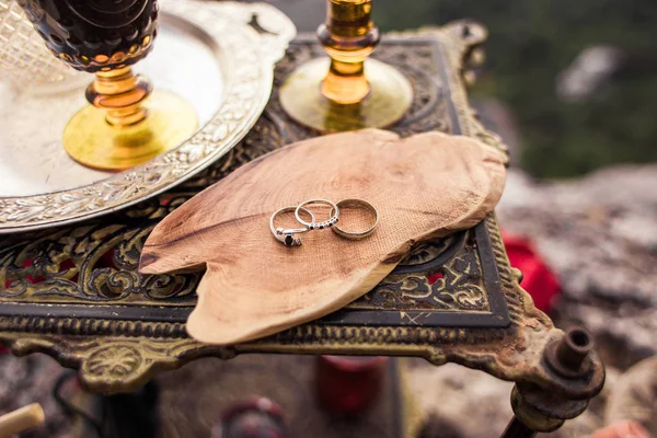 Two wedding rings and engagement on a wooden one cut — Stock Photo, Image