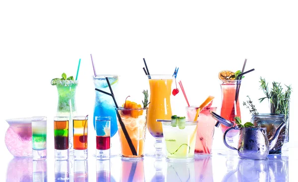A variety of cocktails on a white background with reflection