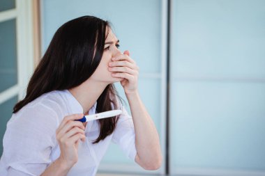 Genç bir kadın pozitif bir hamilelik testi gördüğünde şok olur ve üzülür. Mide bulantısı, kusma, zehirlenme.