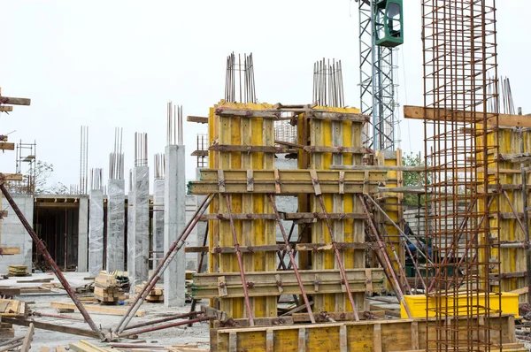 Concrete Pillars Supported With Boards on Construction Site