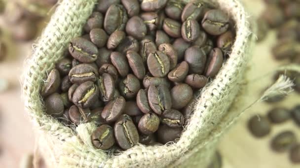 Coffee beans rotating in burlap, close up — Stock Video