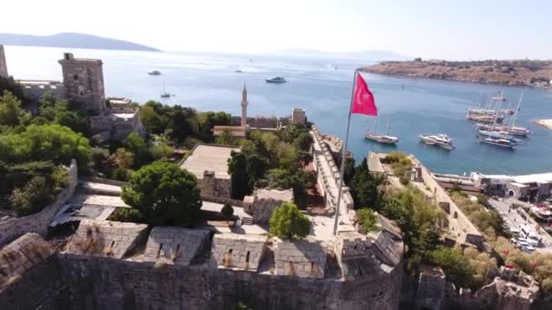 Turkish flag castle marina aerial yacht drone shot business boat harbor luxury tourism coastline travel Bodrum Mugla, Turkey — Stock Video