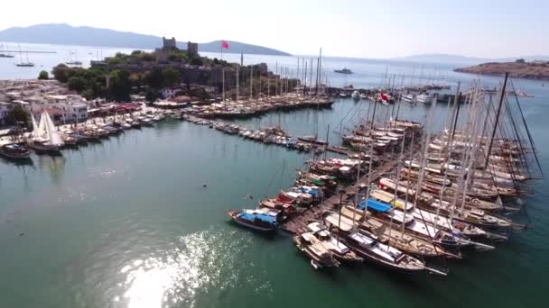 Castle marina aerial yacht Turkish flag drone shot business boat harbor luxury tourism coastline travel Bodrum Mugla, Turkey — Stock Video